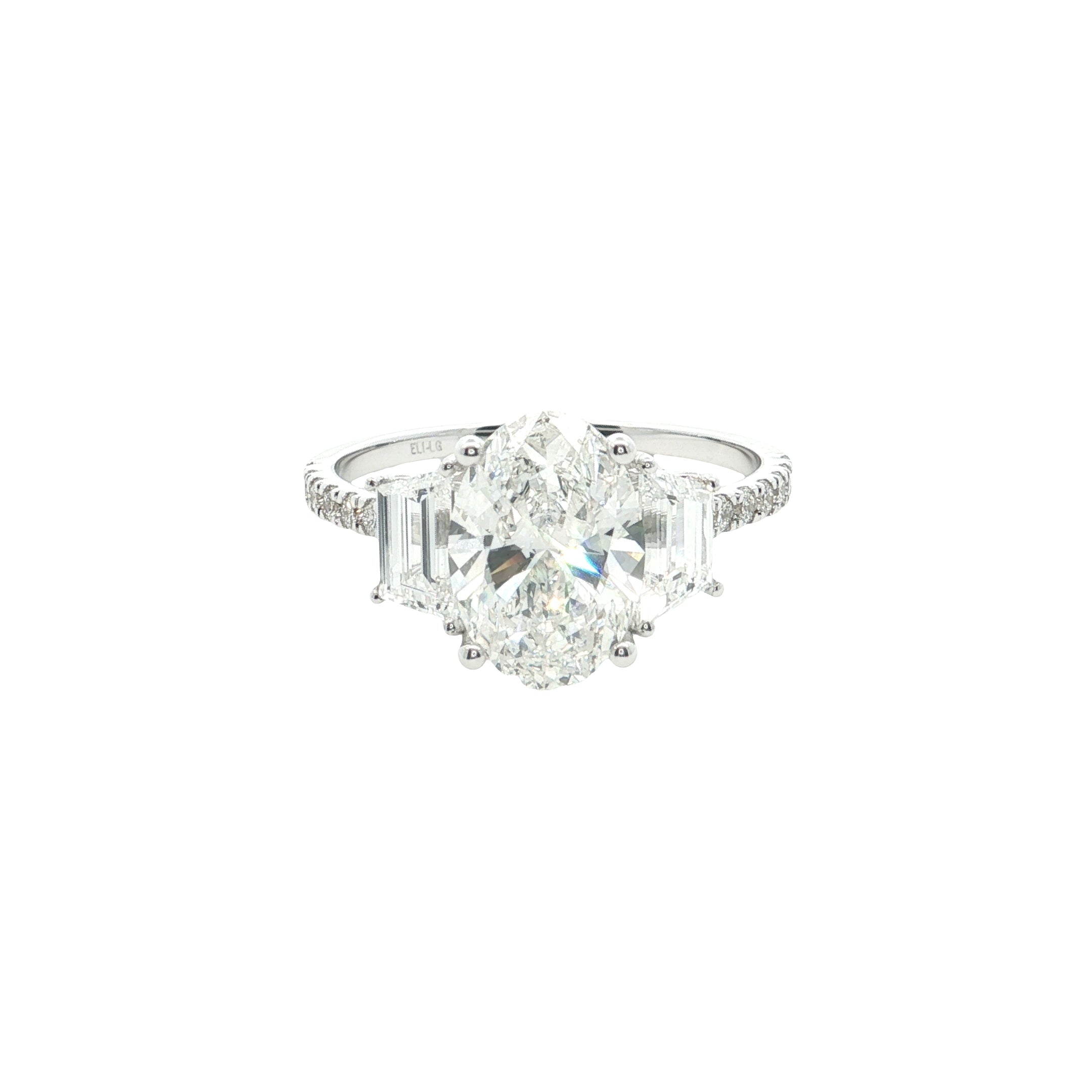 center oval with fancy trapezoid and round brilliant cut diamond engagement ring