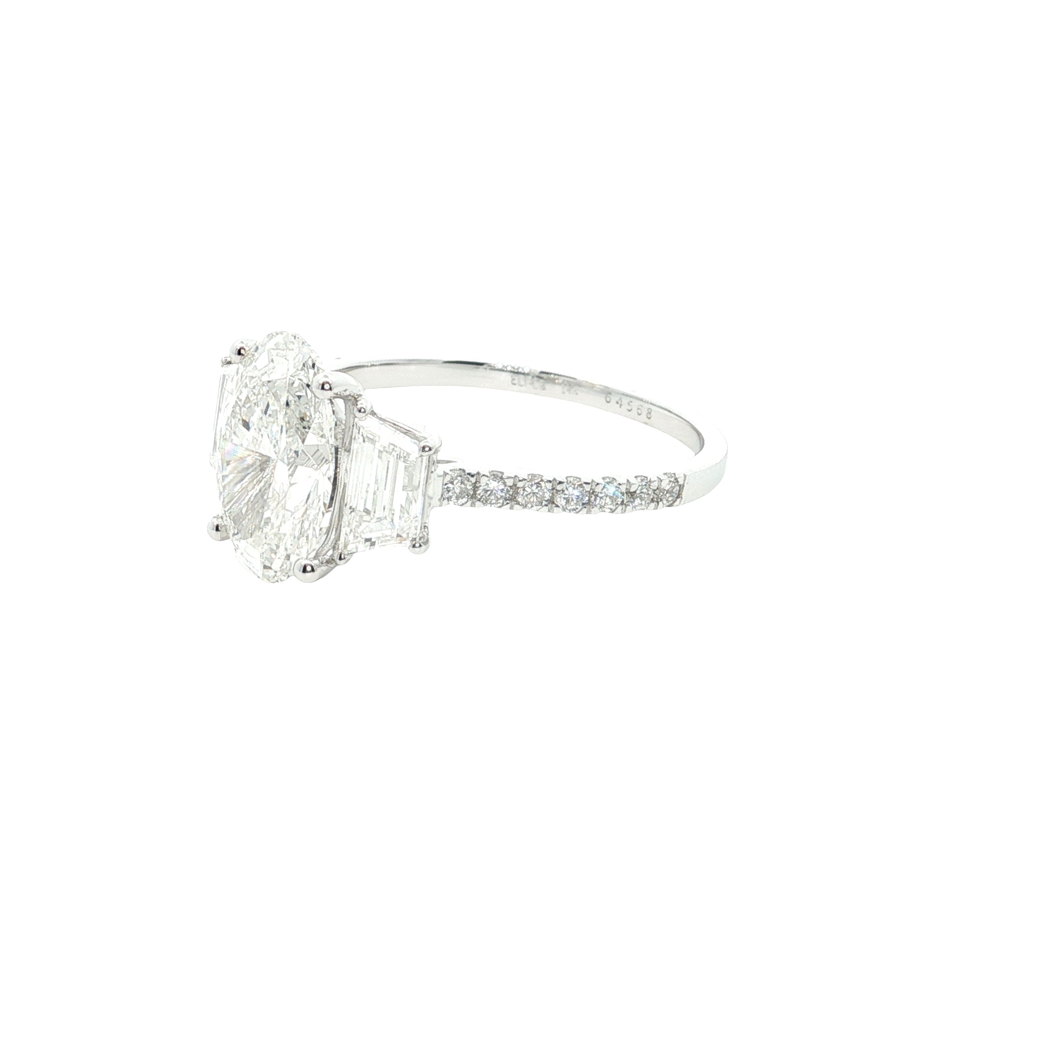 center oval with fancy trapezoid and round brilliant cut diamond engagement ring