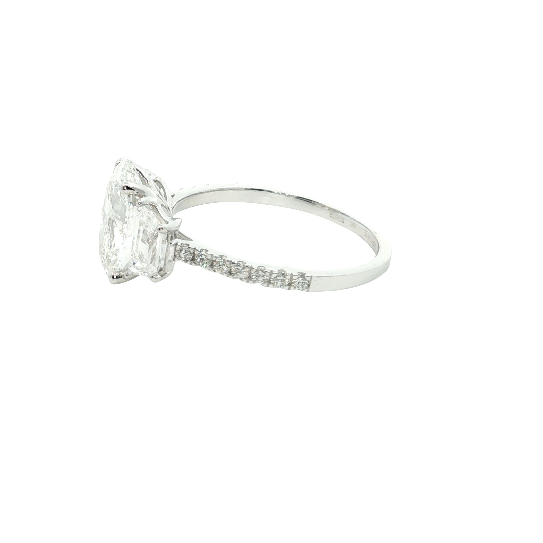 center oval with fancy trapezoid and round brilliant cut diamond engagement ring