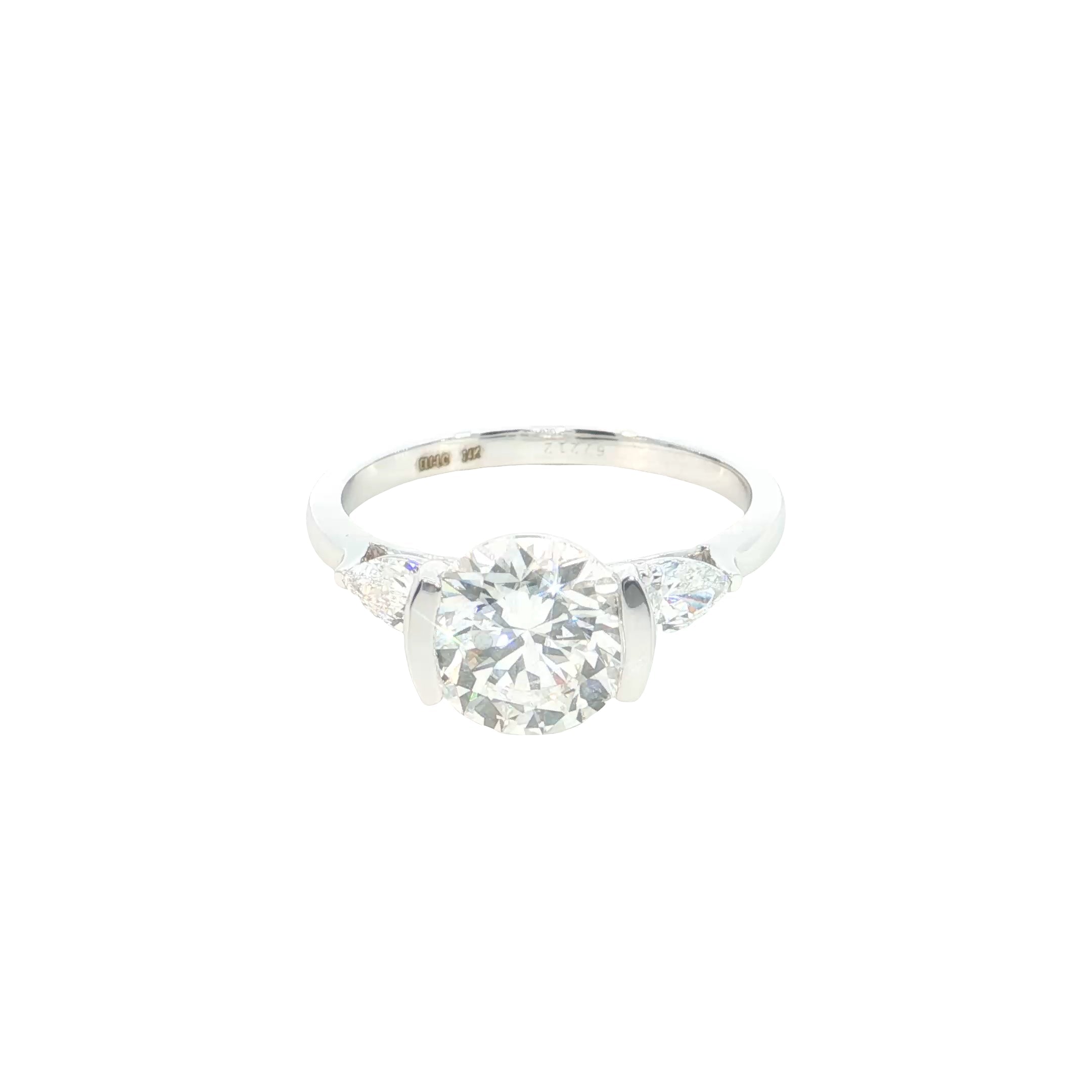 round brilliant cut and pear cut lab grown diamond three stone engagement ring