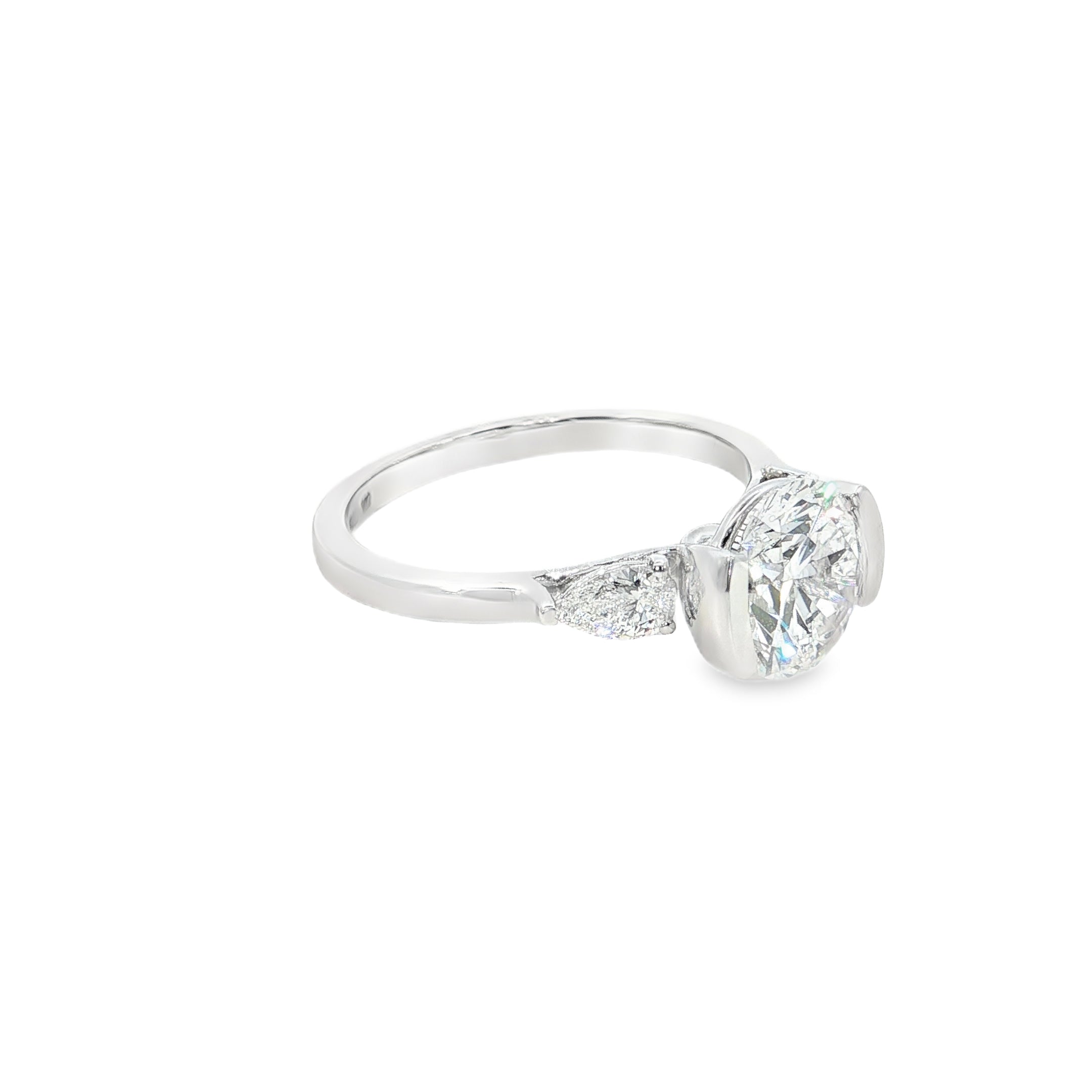 round brilliant cut and pear cut lab grown diamond three stone engagement ring