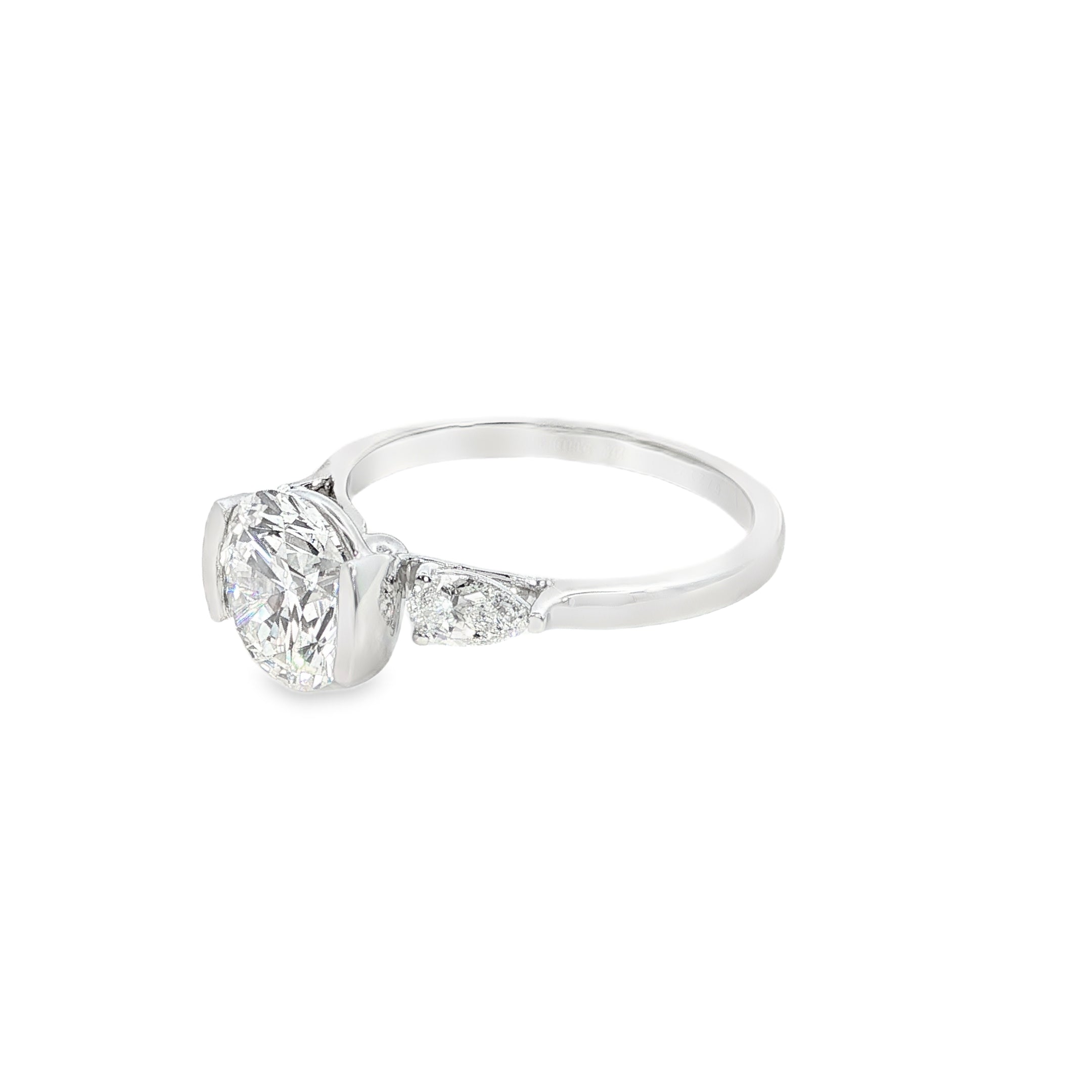 round brilliant cut and pear cut lab grown diamond three stone engagement ring