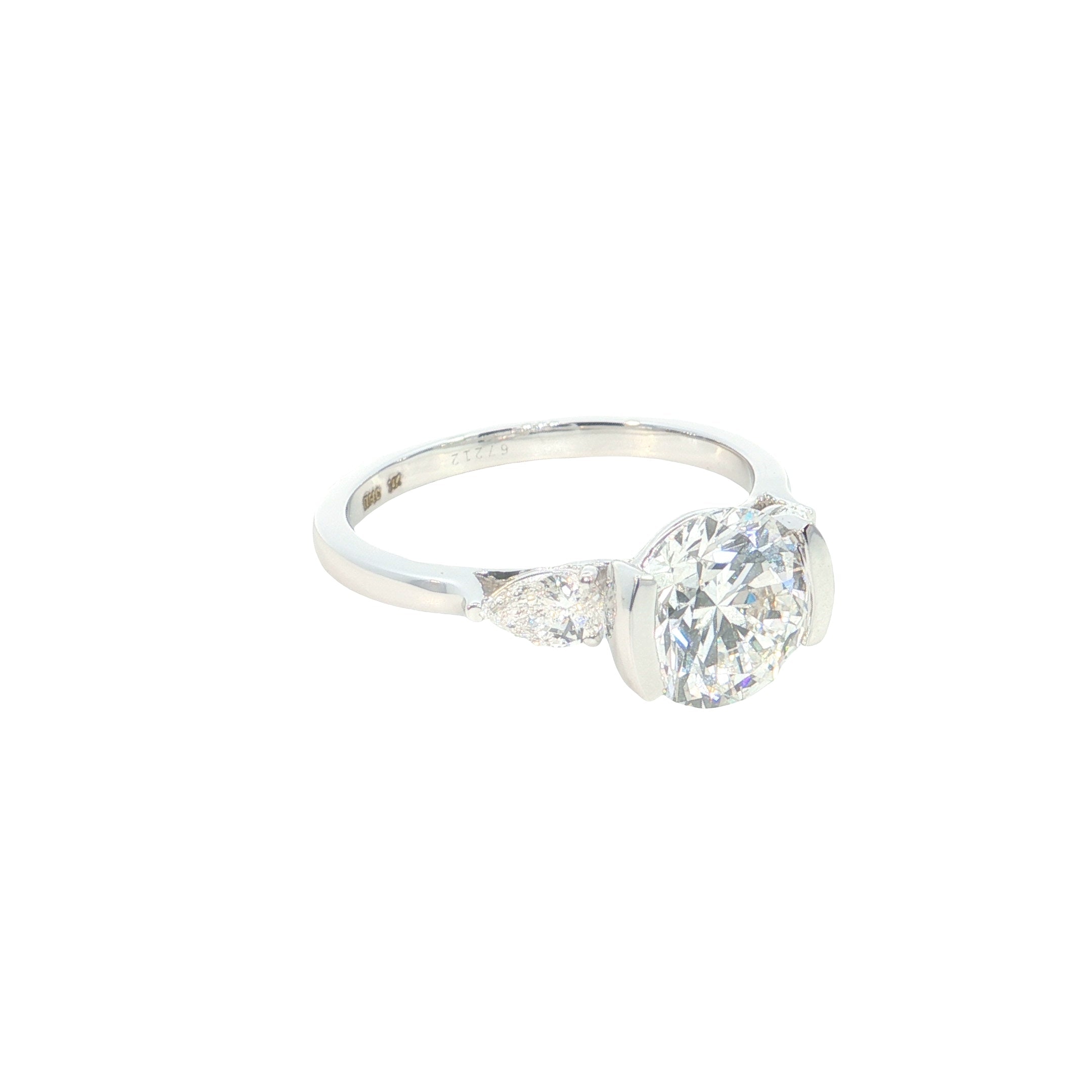 round brilliant cut and pear cut lab grown diamond three stone engagement ring