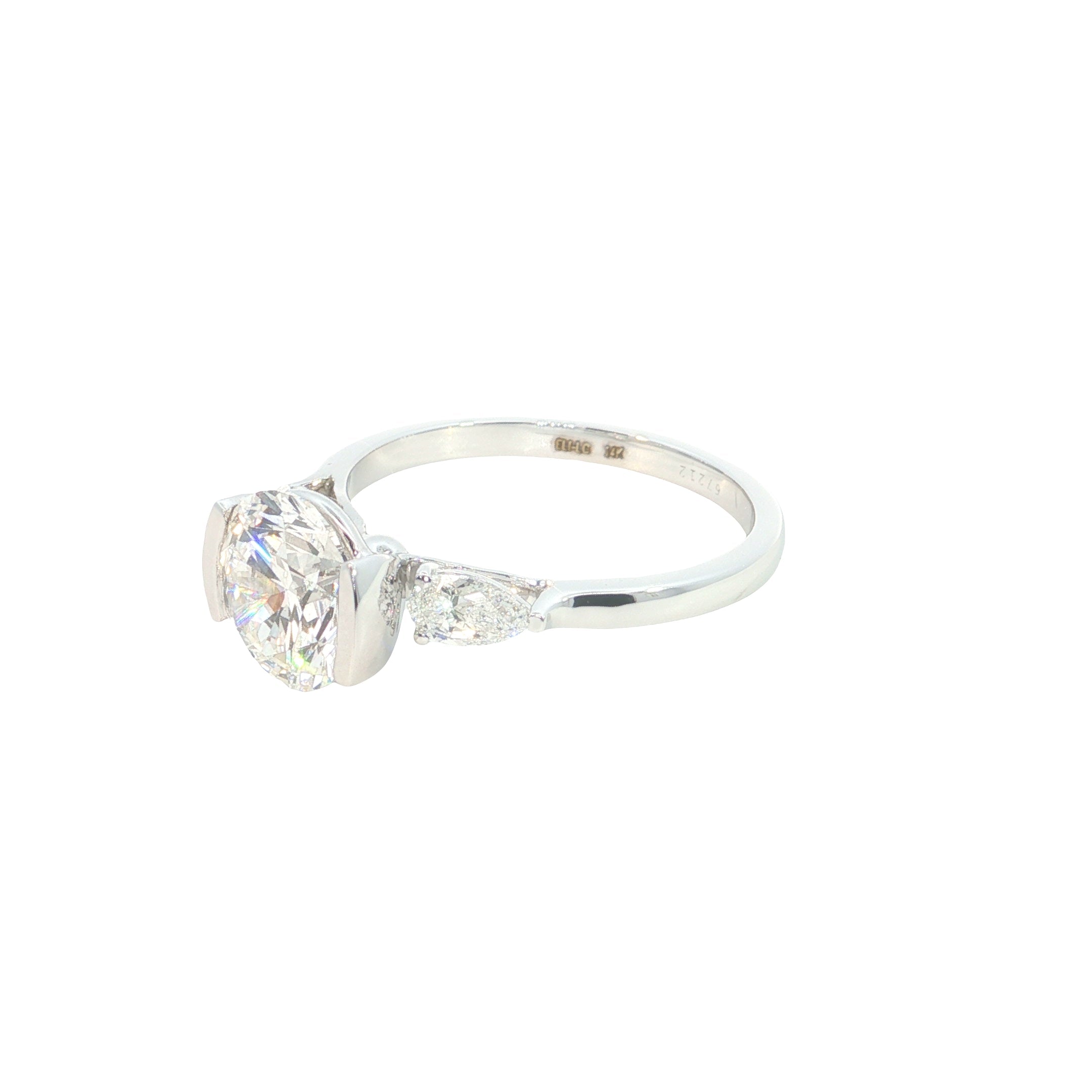 round brilliant cut and pear cut lab grown diamond three stone engagement ring