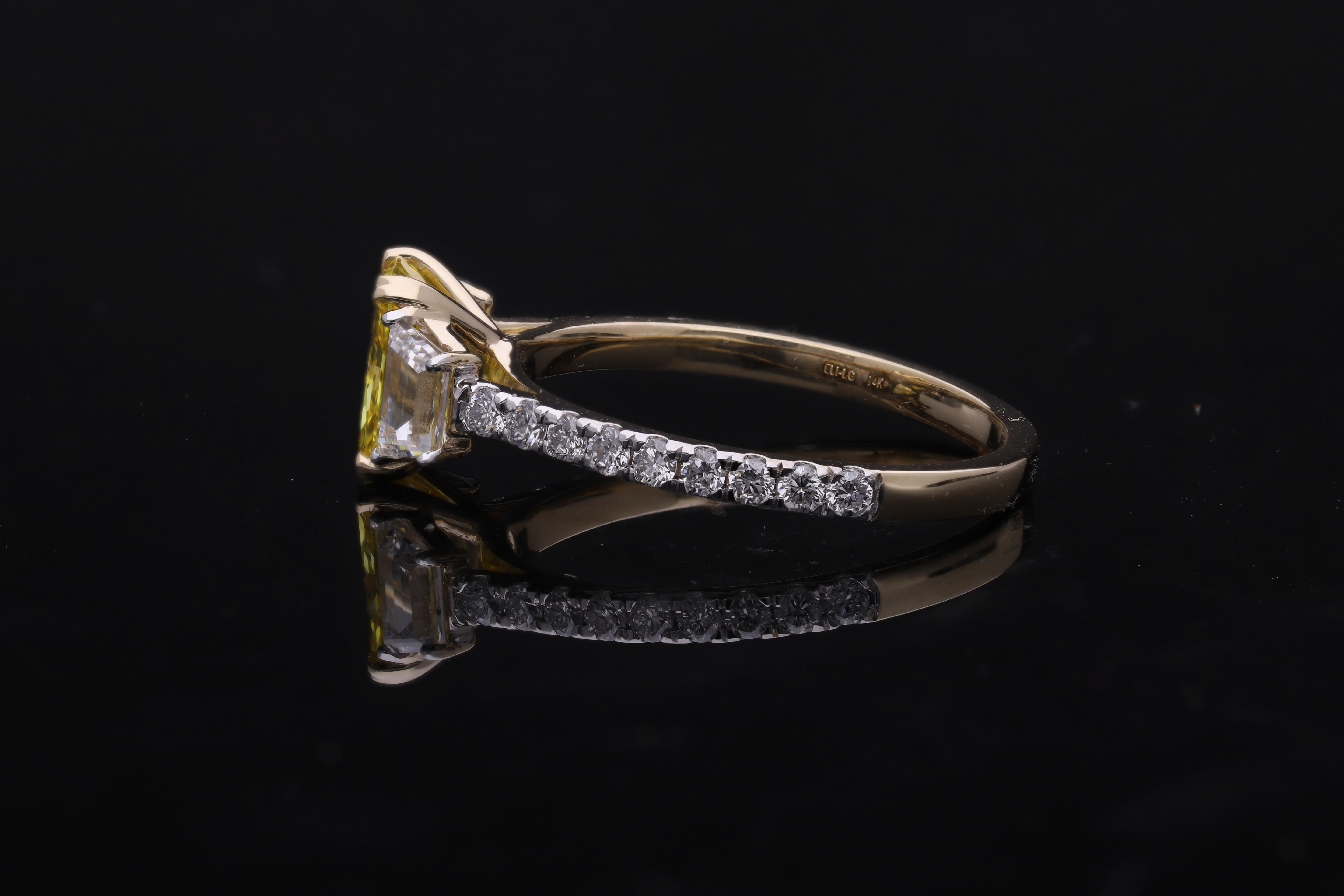 yellow color center radiant  with fancy trapezoid and round brilliant cut diamond engagement ring
