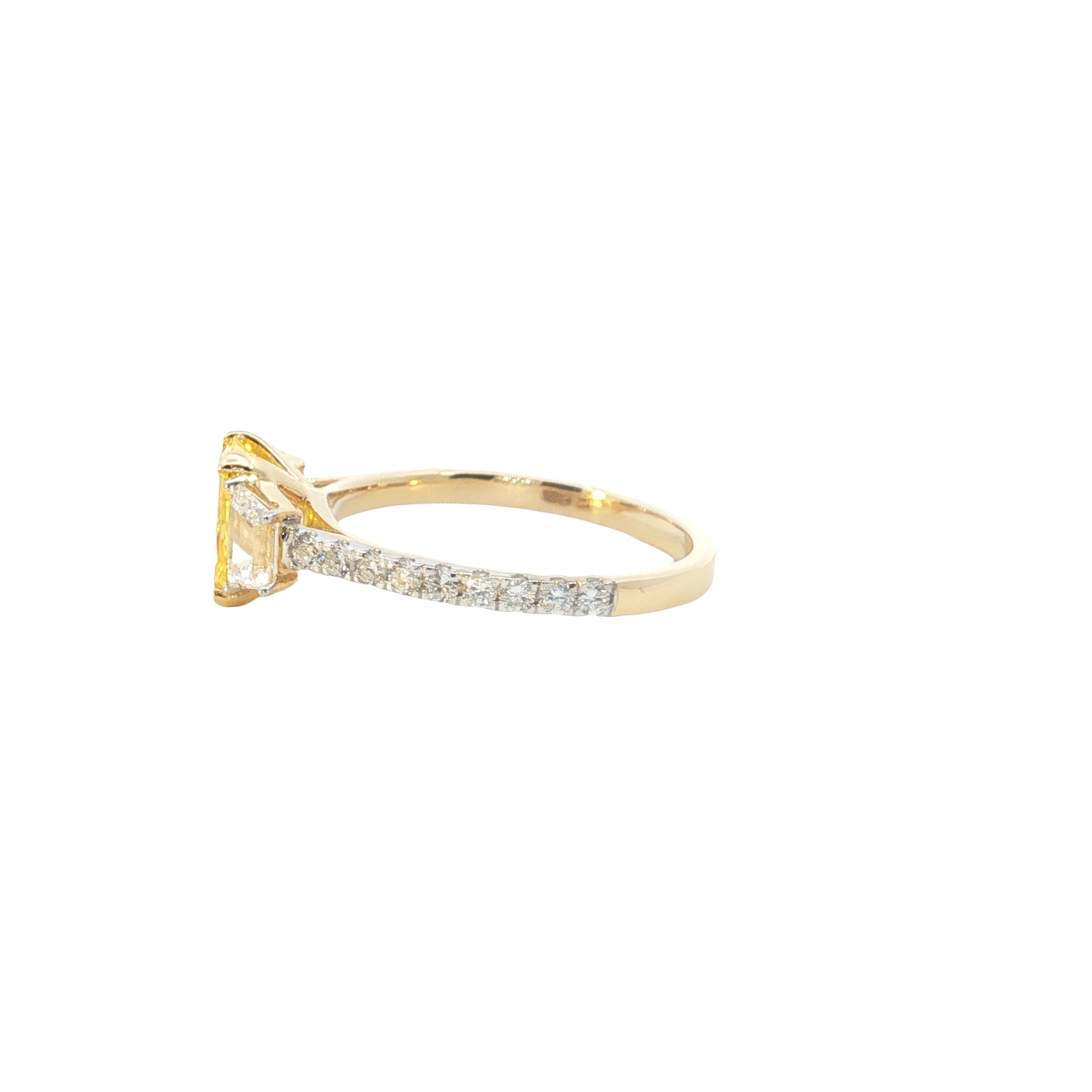 yellow color center radiant  with fancy trapezoid and round brilliant cut diamond engagement ring