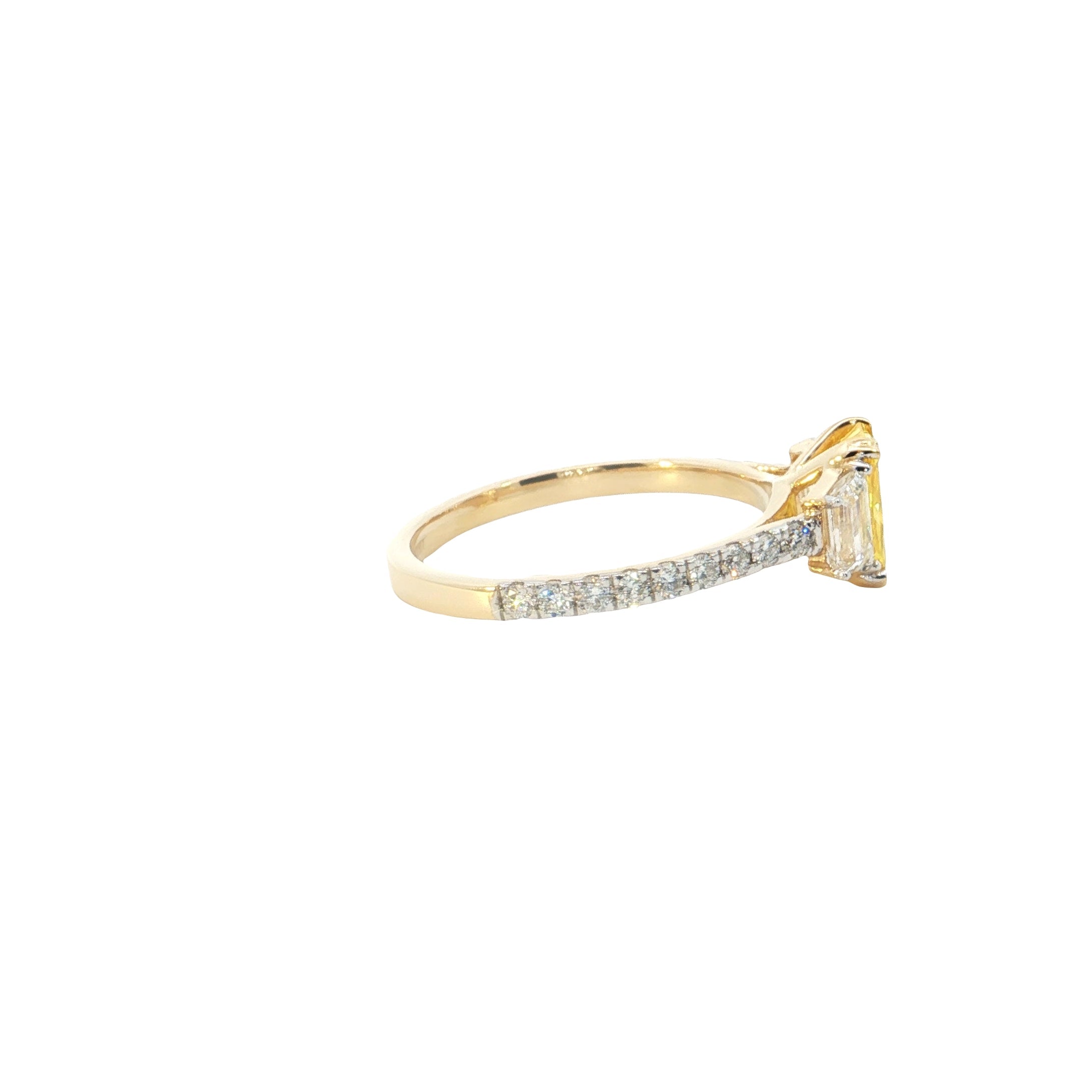 yellow color center radiant  with fancy trapezoid and round brilliant cut diamond engagement ring
