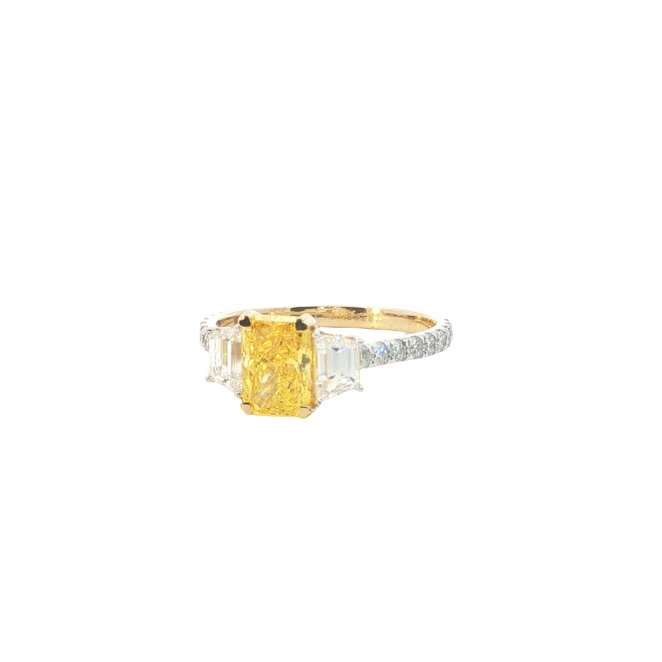 yellow color center radiant  with fancy trapezoid and round brilliant cut diamond engagement ring