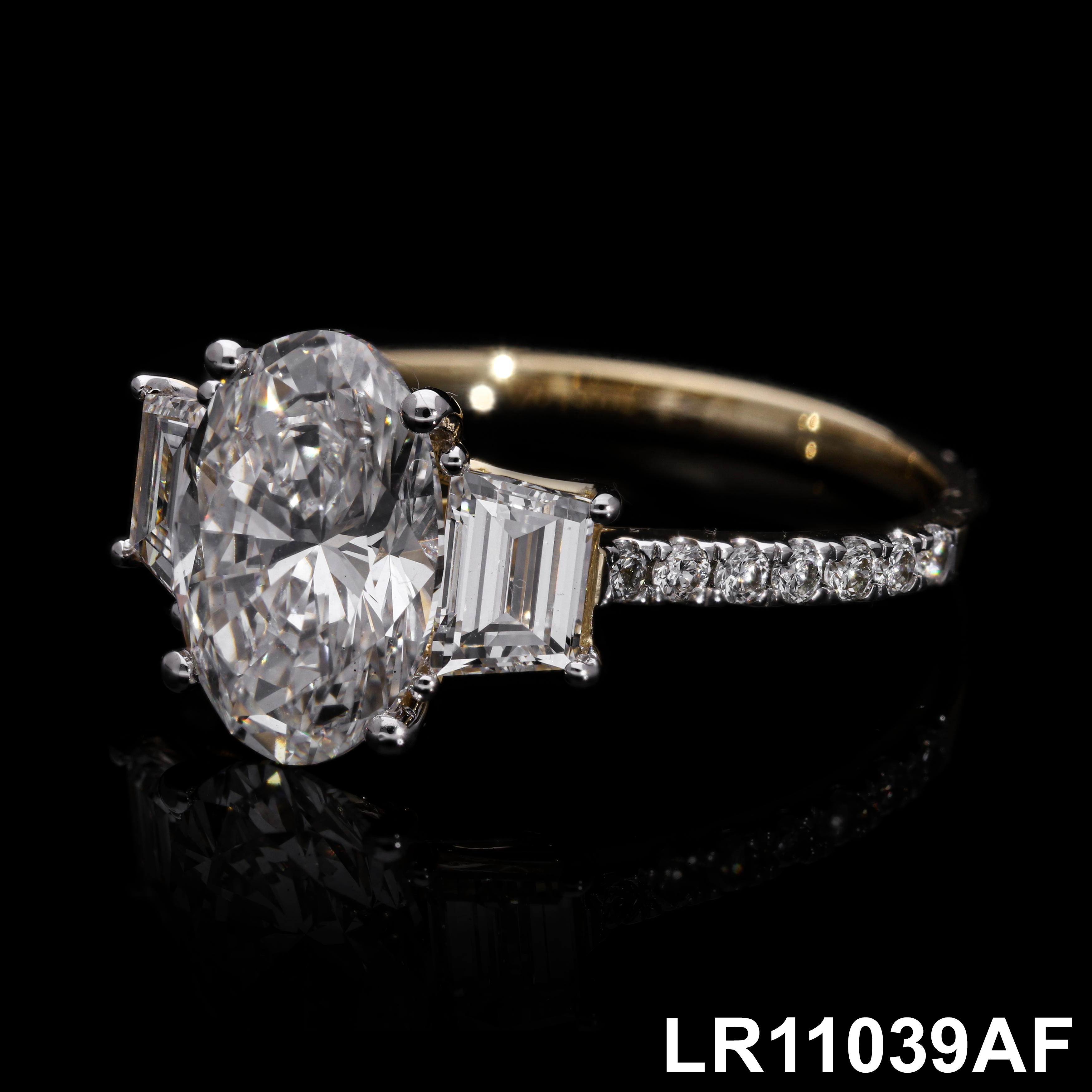 center oval with fancy trapezoid and round brilliant cut diamond engagement ring