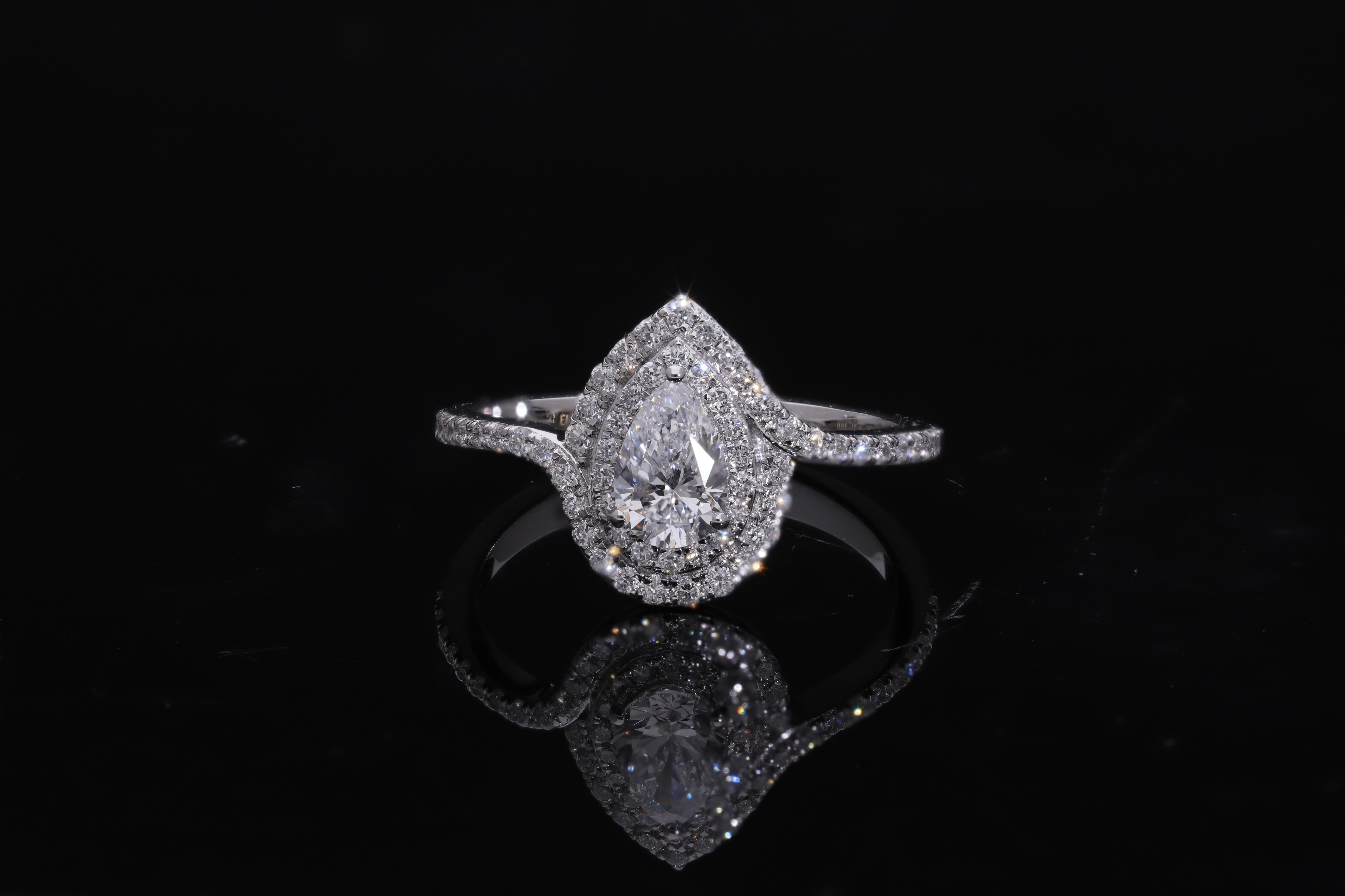 pear center with round brilliant cut halo setting lab grown diamond engagement ring